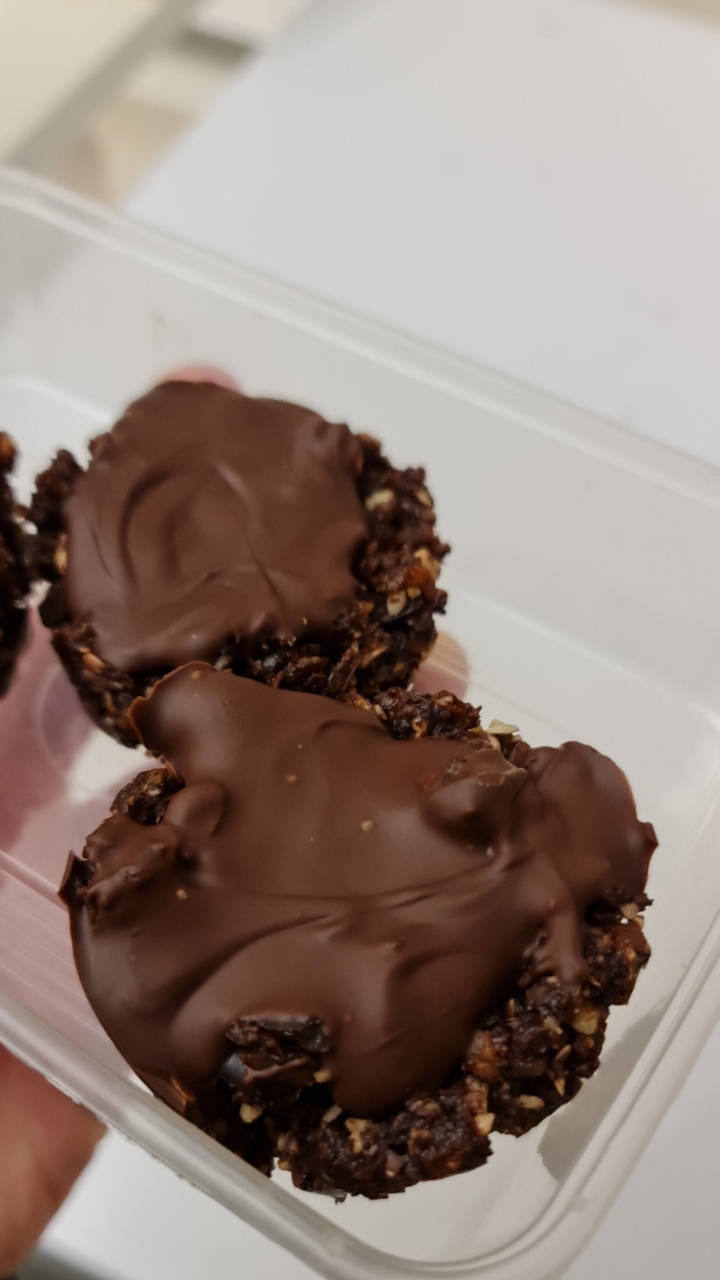 Chocolate-covered clusters in a plastic container