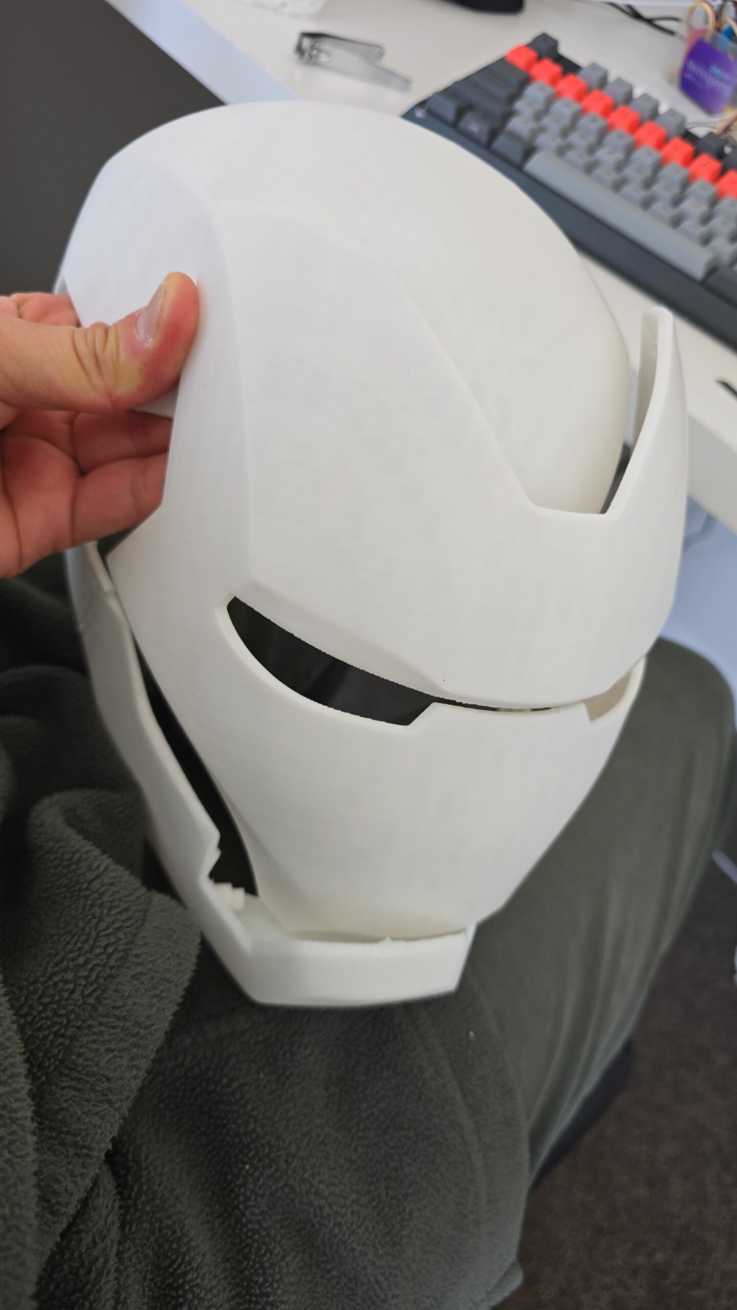 Assembled 3D-printed Iron Man helmet held in hand