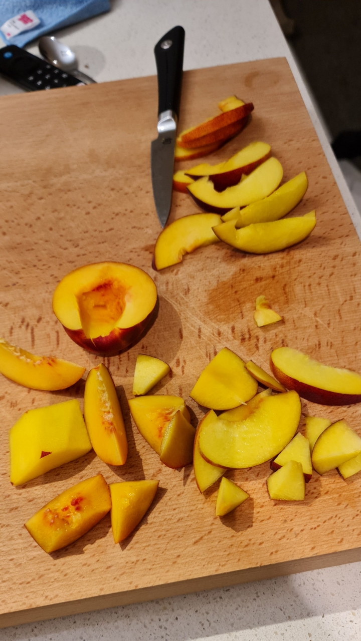 Nectarines sliced and diced on a wooden board