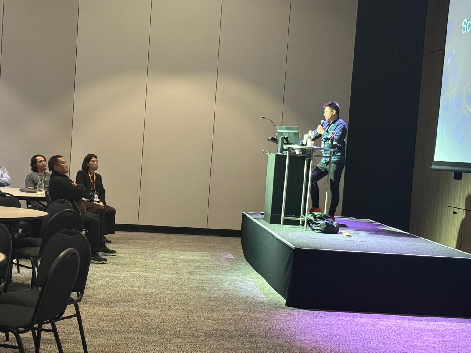 Wide shot of the talk from the back of the room